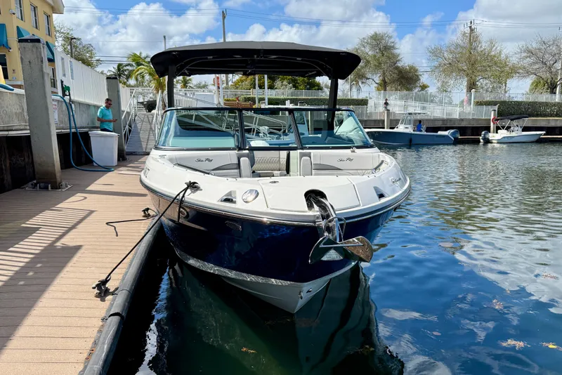 Slide: The Image of 2025 Sea Ray SLX 280 Outboard boat docked in a marina under a clear sky. - 9