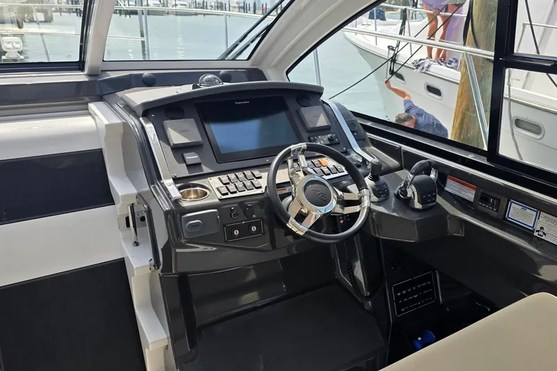 Slide: The Image of Interior of 2017 Monterey 360 Sport Coupe yacht with modern helm and seating. - 16