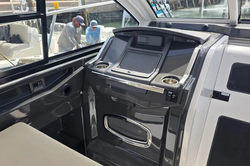 Slide: The Image of 2017 Monterey 360 Sport Coupe helm with modern controls and panoramic view. - 17