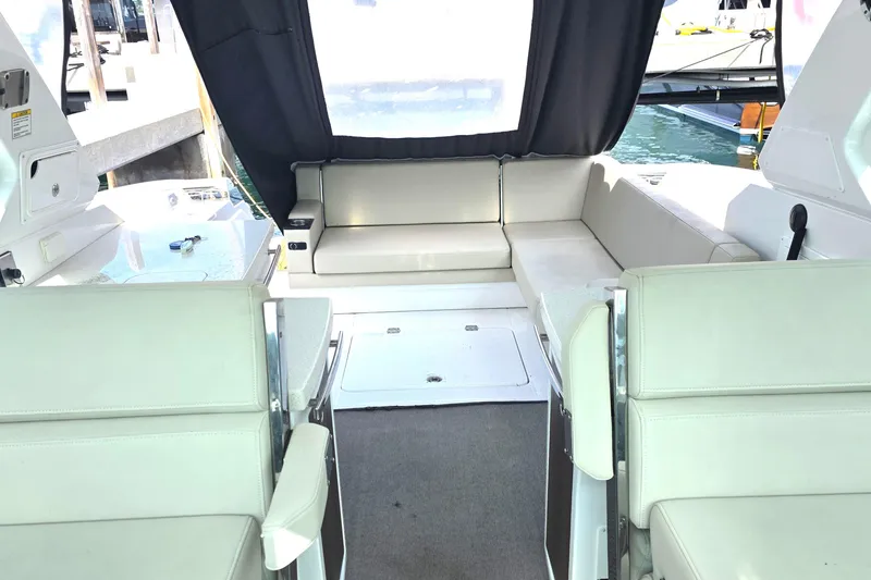 Slide: The Image of Interior of a 2017 Monterey 360 Sport Coupe boat with beige seating and a view of the water. - 21