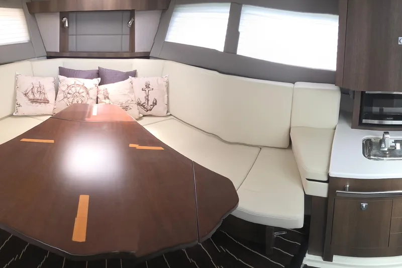 Slide: The Image of Interior of 2017 Monterey 360 Sport Coupe with elegant seating and nautical-themed cushions. - 25