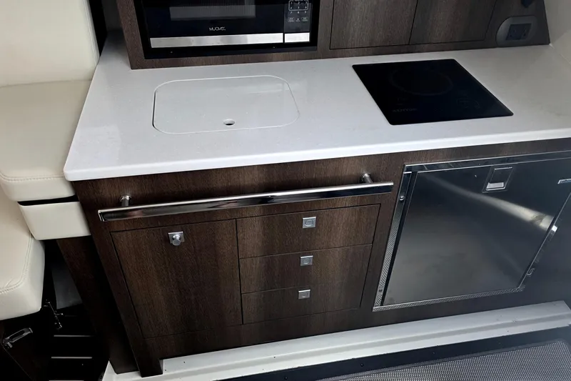 Slide: The Image of 2017 Monterey 360 Sport Coupe interior kitchen with modern appliances and sleek cabinetry. - 27