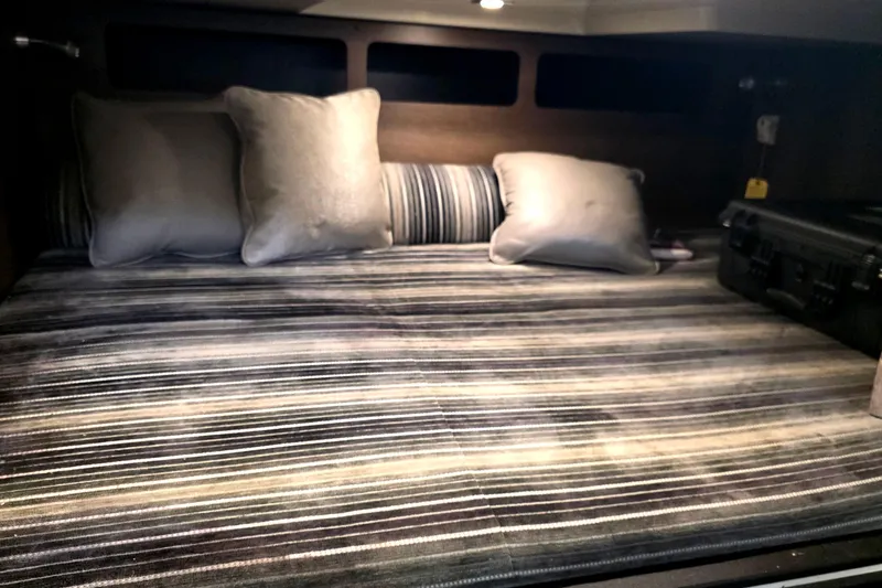 Slide: The Image of 2017 Monterey 360 Sport Coupe interior cabin with striped bedding and cushions. - 32