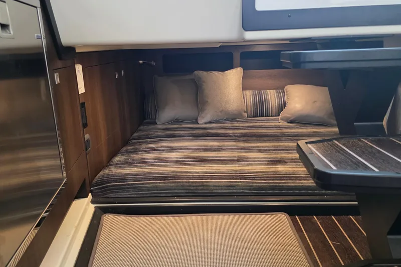 Slide: The Image of Interior cabin of 2017 Monterey 360 Sport Coupe with striped bedding and cushions. - 33