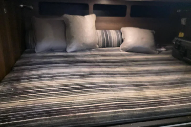 Slide: The Image of Cozy bed with striped bedding in 2017 Monterey 360 Sport Coupe cabin. - 34