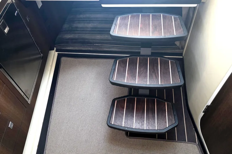 Slide: The Image of Interior stairs of 2017 Monterey 360 Sport Coupe with wooden steps and carpeted flooring. - 38