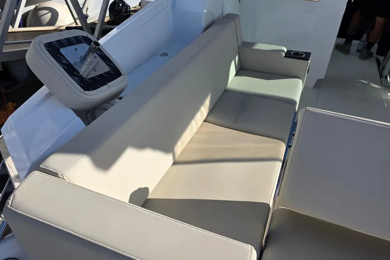 Slide: The Image of Luxurious seating on 2017 Monterey 360 Sport Coupe boat, featuring beige upholstery and cup holder. - 46