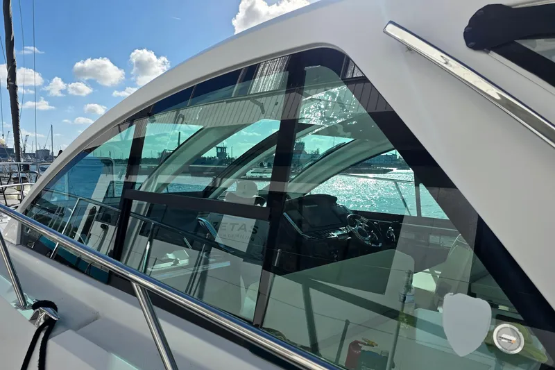 Slide: The Image of 2017 Monterey 360 Sport Coupe yacht with sleek design, docked under a sunny sky. - 47