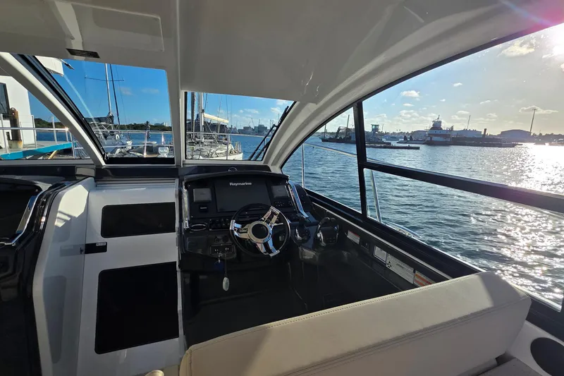 Slide: The Image of Interior view of 2017 Monterey 360 Sport Coupe yacht cockpit with waterfront scenery. - 51
