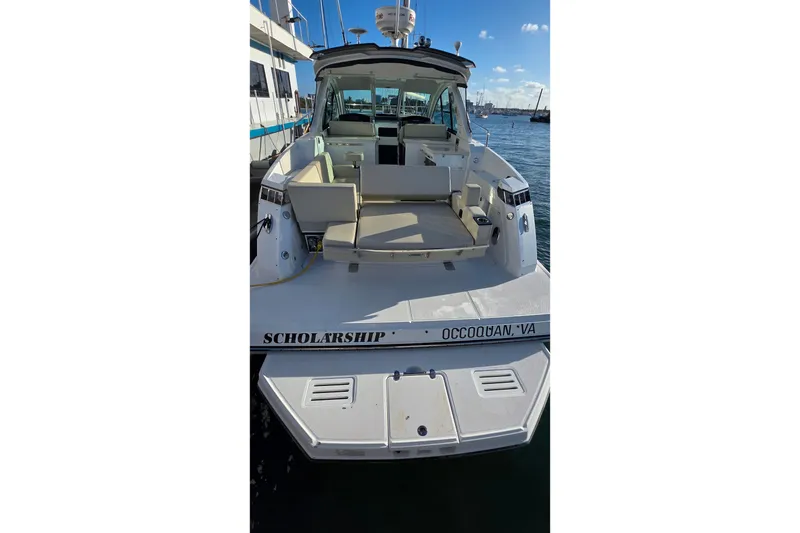 Slide: The Image of 2017 Monterey 360 Sport Coupe yacht docked, rear view with seating area, sunny day. - 52