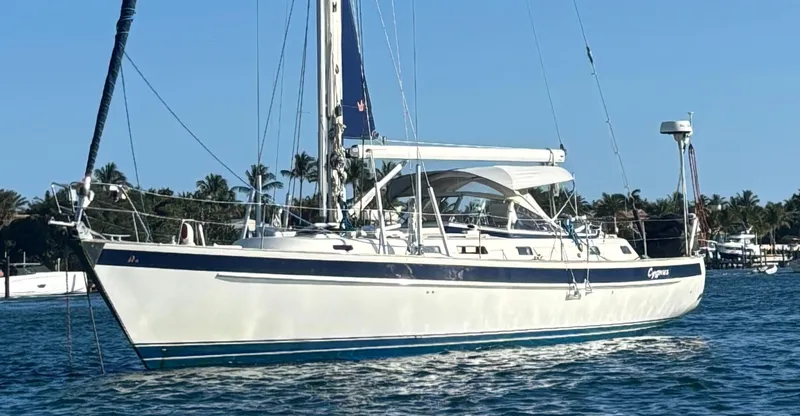 The Image of Hallberg-Rassy 46 sailboat from 2000 on calm water, clear sky background. - 1