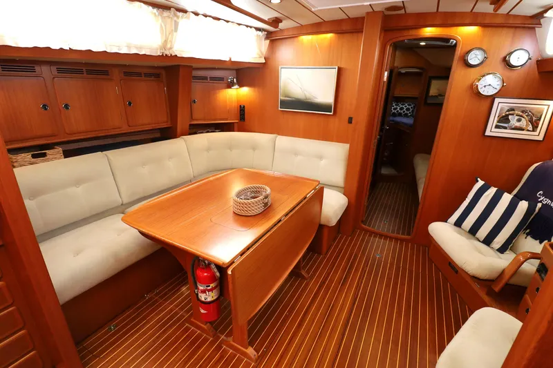 Slide: The Image of Luxurious interior of 2000 Hallberg-Rassy 46 yacht with wooden furnishings and cozy seating. - 11