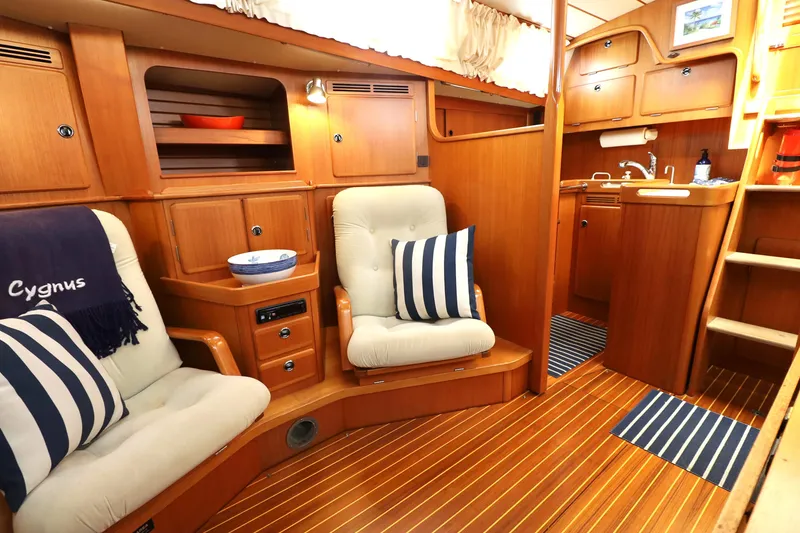 Slide: The Image of Luxurious interior of 2000 Hallberg-Rassy 46 yacht with cozy seating and wooden cabinetry. - 12