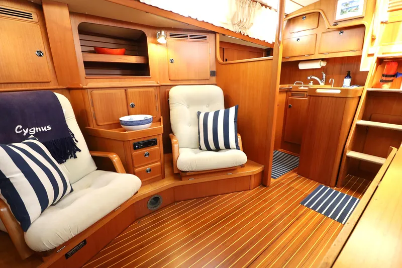 Slide: The Image of Luxurious interior of 2000 Hallberg-Rassy 46 yacht with cozy seating and wooden finishes. - 13