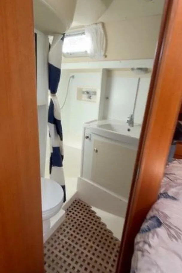 Slide: The Image of Hallberg-Rassy 46 (2000) yacht bathroom with shower, sink, and toilet. - 15