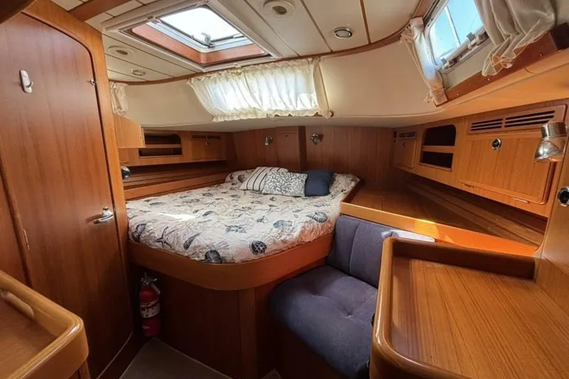 Slide: The Image of Cozy cabin interior of 2000 Hallberg-Rassy 46 yacht with wood finish and skylight. - 17