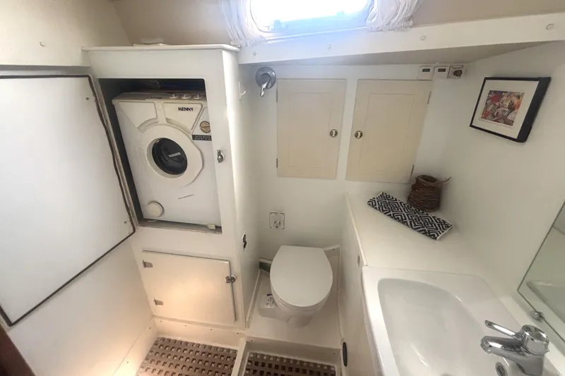 Slide: The Image of Bathroom interior of 2000 Hallberg-Rassy 46 yacht with washer, toilet, and sink. - 20