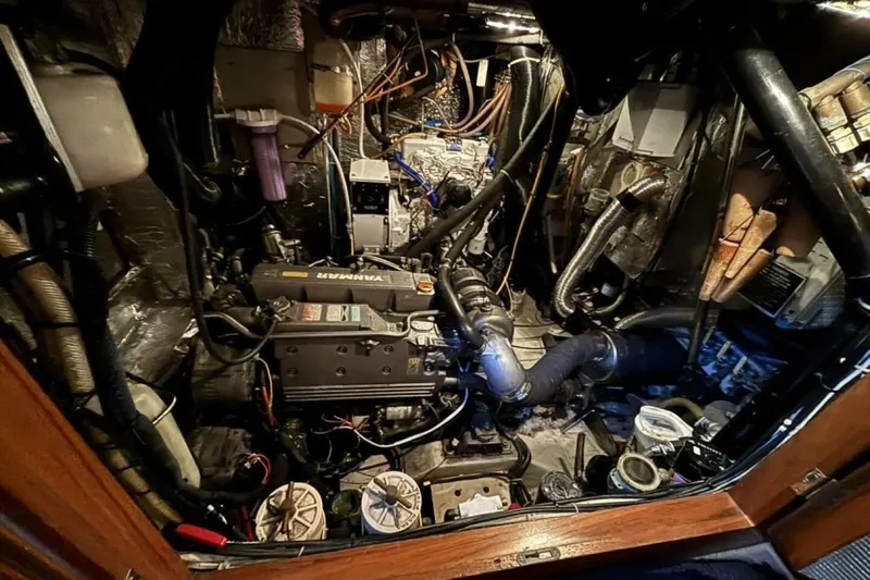 Slide: The Image of Engine room of a 2000 Hallberg-Rassy 46 yacht, showcasing complex machinery and components. - 23
