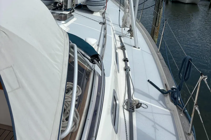 Slide: The Image of Deck view of a 2000 Hallberg-Rassy 46 sailboat, featuring rigging and ropes. - 28