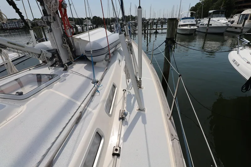 Slide: The Image of Deck view of a 2000 Hallberg-Rassy 46 sailboat docked at a marina. - 29