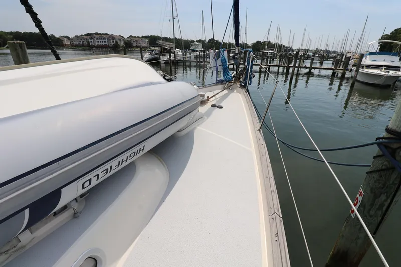 Slide: The Image of Hallberg-Rassy 46 sailboat deck with dinghy, docked in a marina, 2000 model. - 31