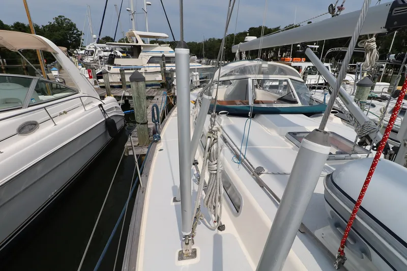 Slide: The Image of 2000 Hallberg-Rassy 46 sailboat docked at a marina, surrounded by other boats. - 32