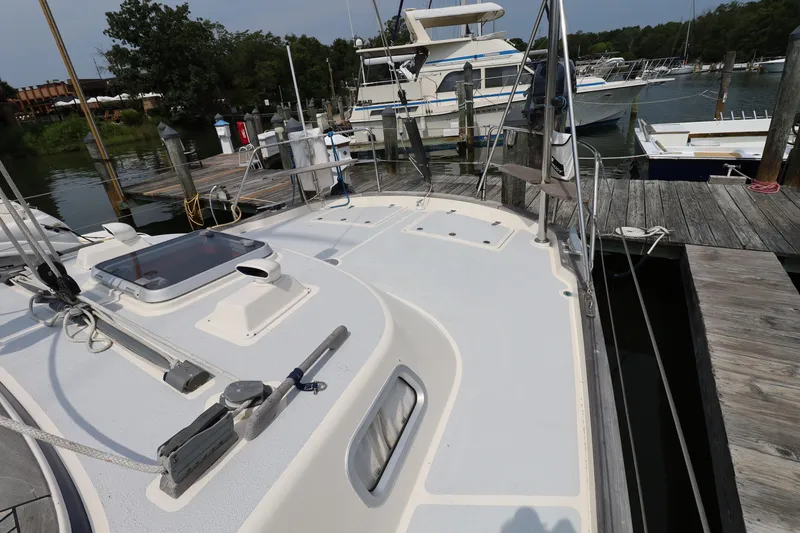 Slide: The Image of Deck view of a 2000 Hallberg-Rassy 46 yacht docked at a marina. - 36