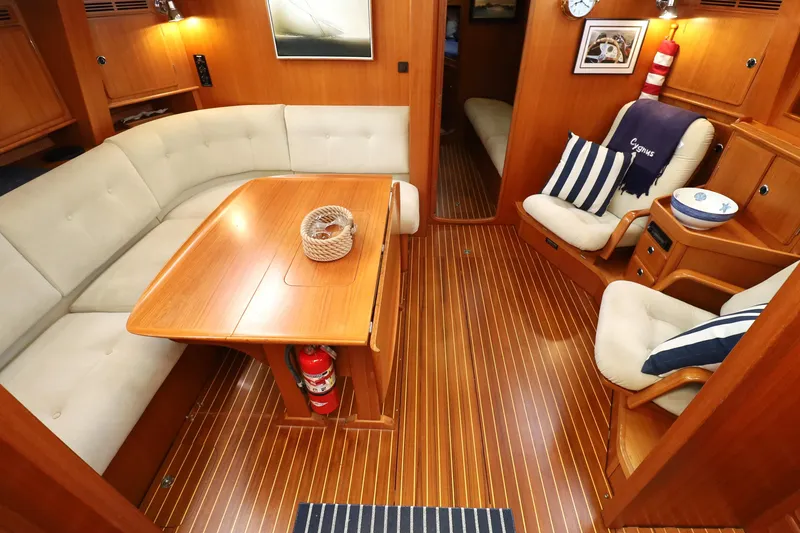 Slide: The Image of Luxurious interior of 2000 Hallberg-Rassy 46 yacht with elegant wood finish and cozy seating. - 5