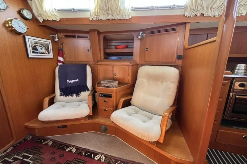 Slide: The Image of Cozy seating area in a 2000 Hallberg-Rassy 46 yacht interior. - 9