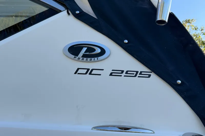 Slide: The Image of 2017 Pursuit DC 295 Dual Console boat logo and model name on hull. - 13