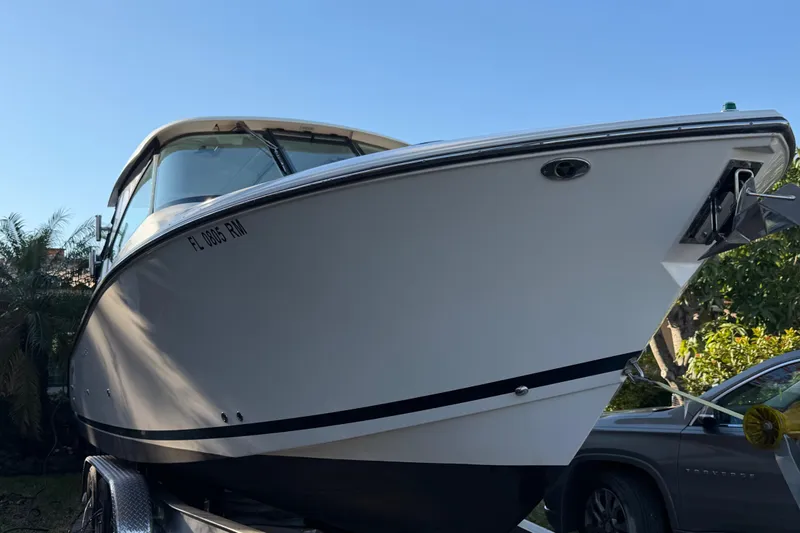 Slide: The Image of 2017 Pursuit DC 295 Dual Console boat on trailer, side view under clear blue sky. - 15