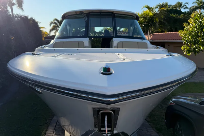 Slide: The Image of 2017 Pursuit DC 295 Dual Console boat, front view, parked outdoors. - 17