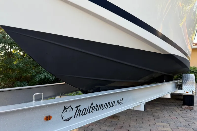 Slide: The Image of 2017 Pursuit DC 295 Dual Console boat on a Trailemania trailer, parked on a brick driveway. - 19