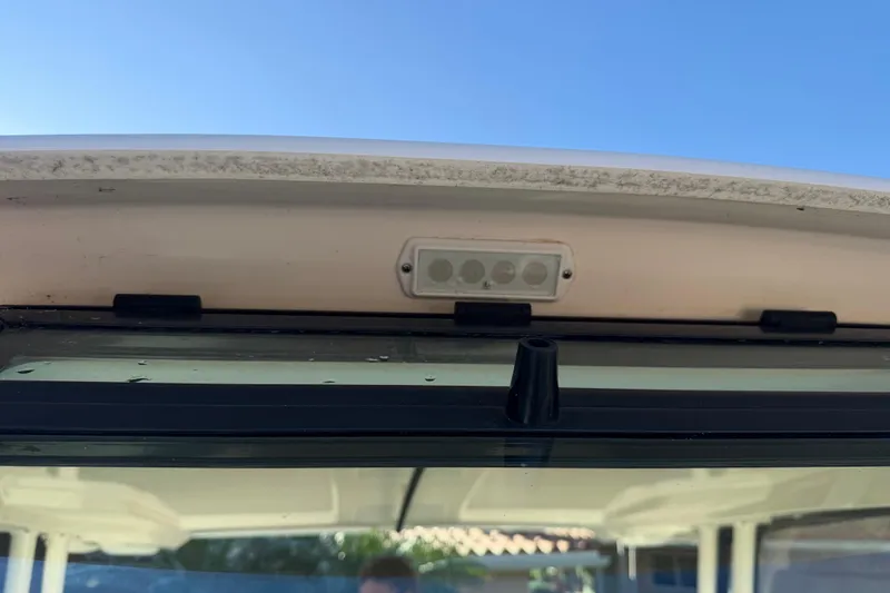 Slide: The Image of 2017 Pursuit DC 295 Dual Console boat windshield and LED light detail. - 24