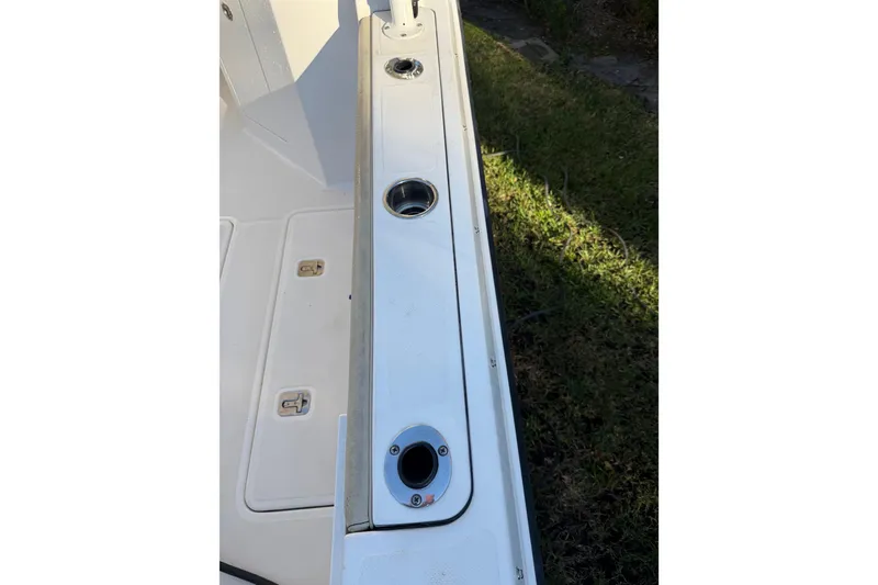 Slide: The Image of 2017 Pursuit DC 295 Dual Console boat deck with rod holders and storage compartments. - 25