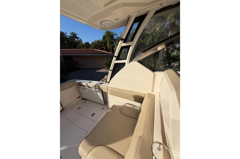 Slide: The Image of 2017 Pursuit DC 295 Dual Console interior with beige seating and windows. - 31