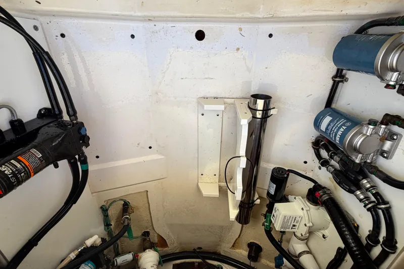 Slide: The Image of 2017 Pursuit DC 295 Dual Console boat engine compartment with various mechanical components. - 38