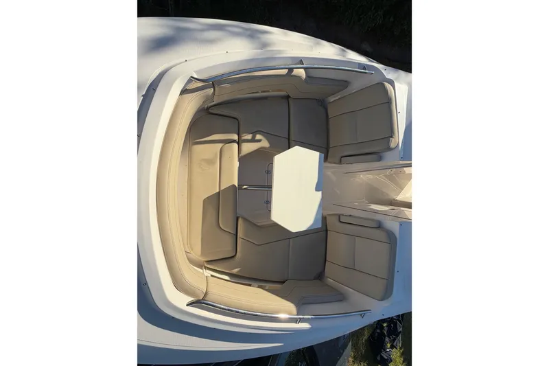 Slide: The Image of 2017 Pursuit DC 295 Dual Console boat interior with beige seating and table. - 40
