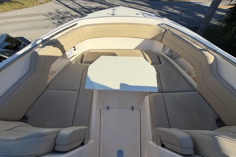 Slide: The Image of 2017 Pursuit DC 295 Dual Console boat with beige seating and a central table. - 41
