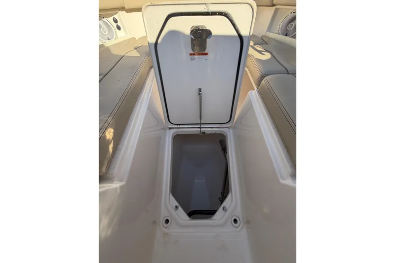 Slide: The Image of Open storage compartment on 2017 Pursuit DC 295 Dual Console boat. - 43