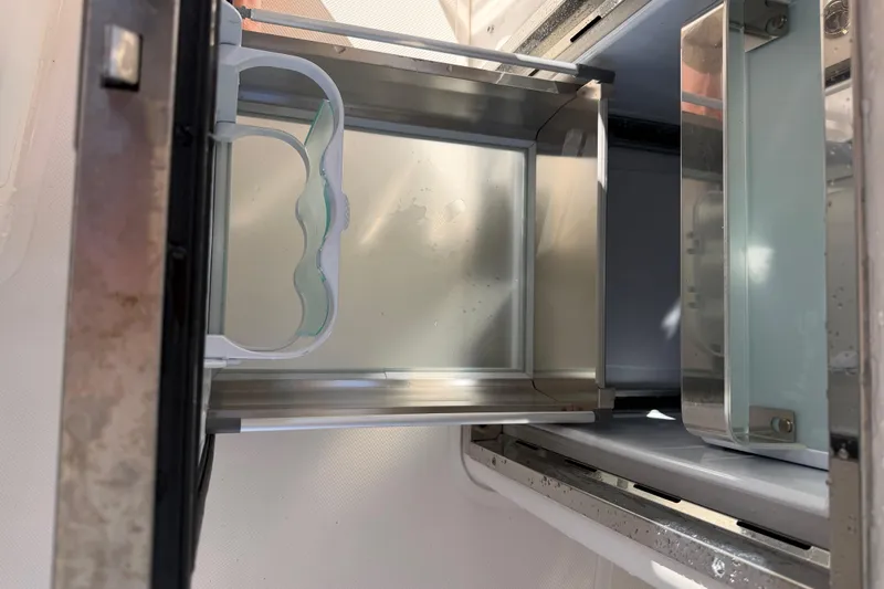 Slide: The Image of Open storage compartment in 2017 Pursuit DC 295 Dual Console boat. - 45