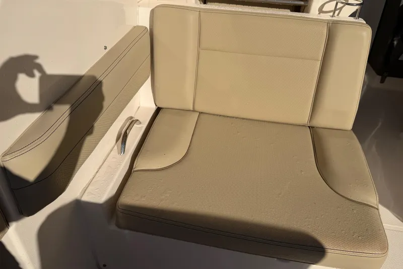Slide: The Image of Beige seating on 2017 Pursuit DC 295 Dual Console boat, with sunlight and shadow. - 46