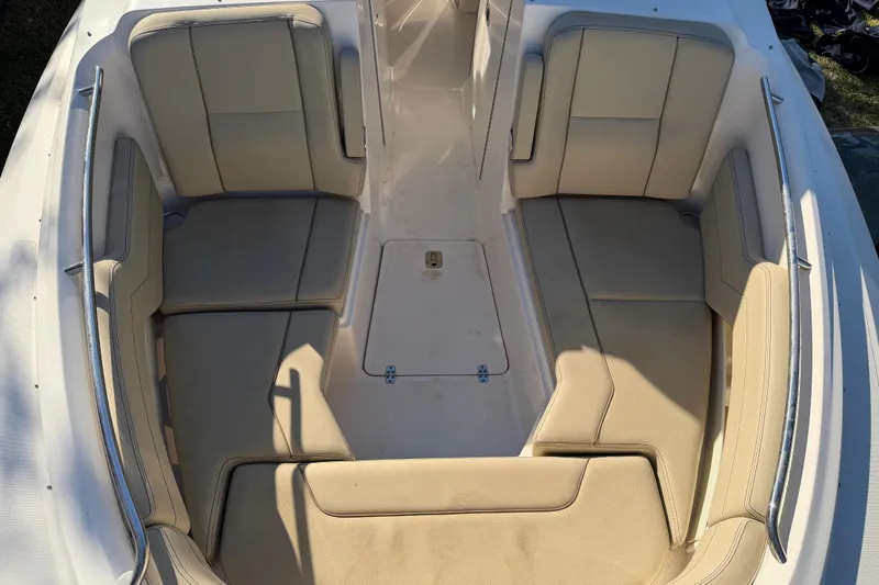 Slide: The Image of 2017 Pursuit DC 295 Dual Console boat interior with beige seating and spacious layout. - 48