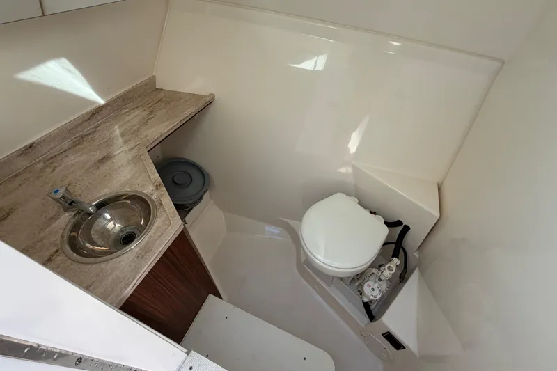 Slide: The Image of 2017 Pursuit DC 295 Dual Console boat bathroom with sink and toilet. - 52