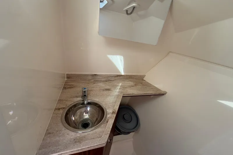 Slide: The Image of 2017 Pursuit DC 295 Dual Console boat interior with sink and countertop. - 53