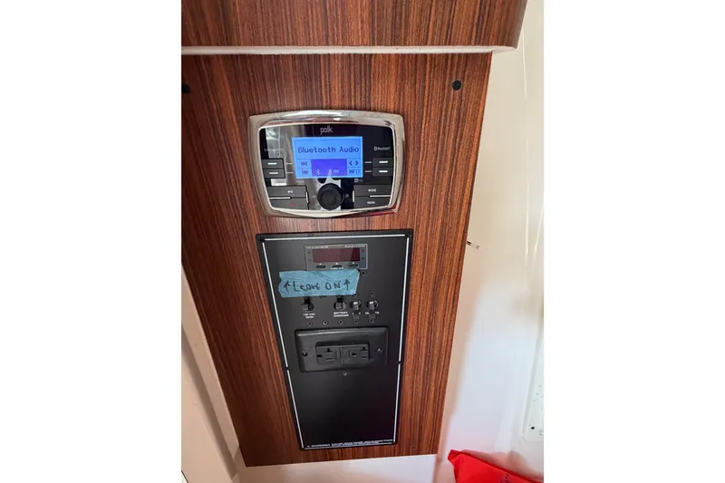 Slide: The Image of 2017 Pursuit DC 295 Dual Console audio control panel with Bluetooth functionality. - 56