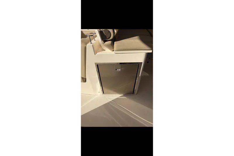 Slide: The Image of 2017 Pursuit DC 295 Dual Console interior with built-in storage compartment. - 65