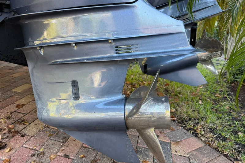 Slide: The Image of 2017 Pursuit DC 295 Dual Console boat propellers on a brick driveway. - 66