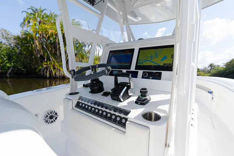 Slide: The Image of 2024 Invincible 33 Open Fisherman boat dashboard with navigation screens and controls. - 11
