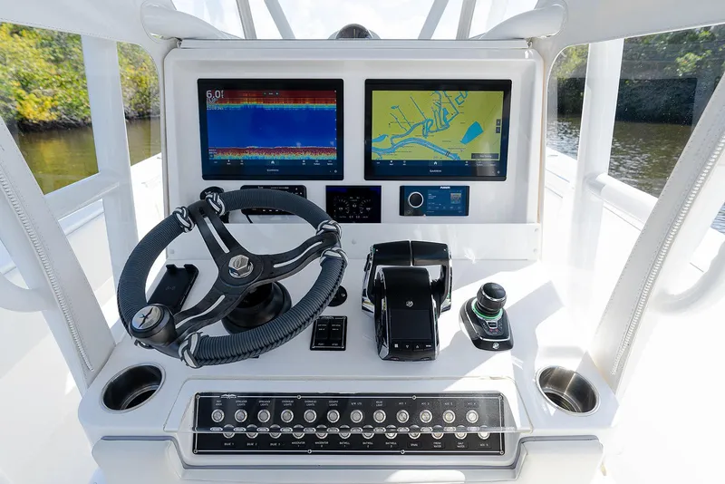 Slide: The Image of 2024 Invincible 33 Open Fisherman dashboard with advanced navigation and control systems. - 13